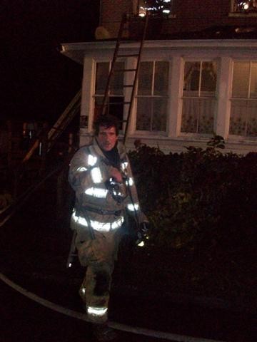 Firefighter Vince Brown after exiting a house fire on South Fourth Street.